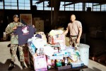 CW2 Fochen Horton Jr. and SGT of the 163 Ord Company with their units Christmas gifts,&nbsp;2004
